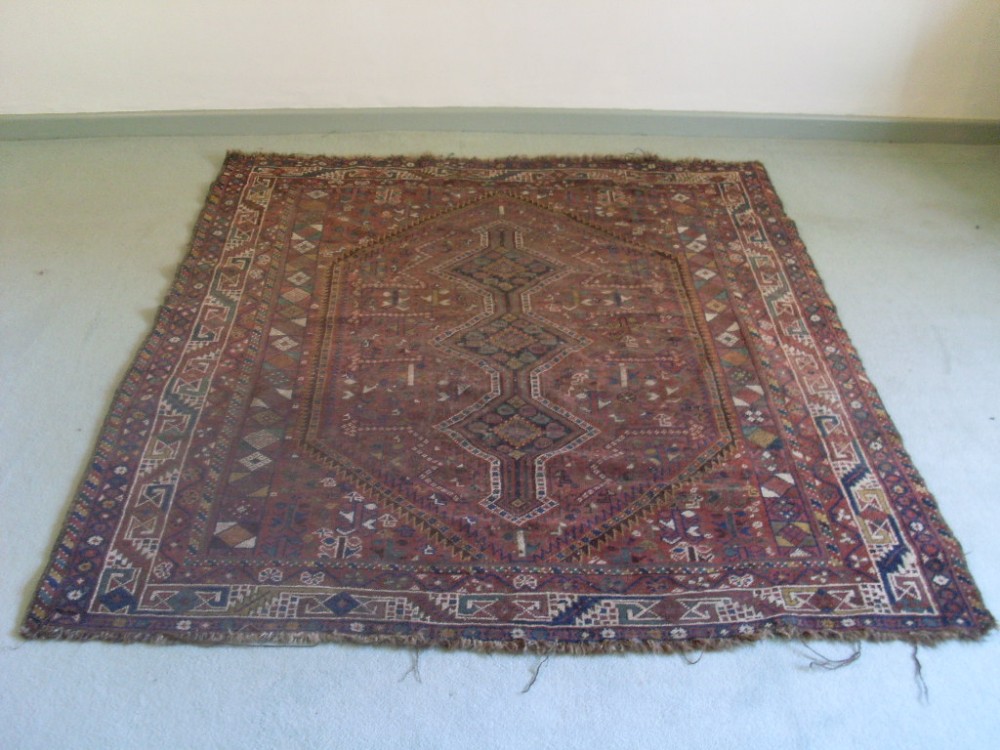 An antique rug 184 cms by 156 cms