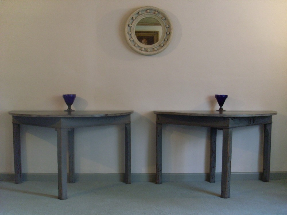 An impressive PAIR of painted demilune tables