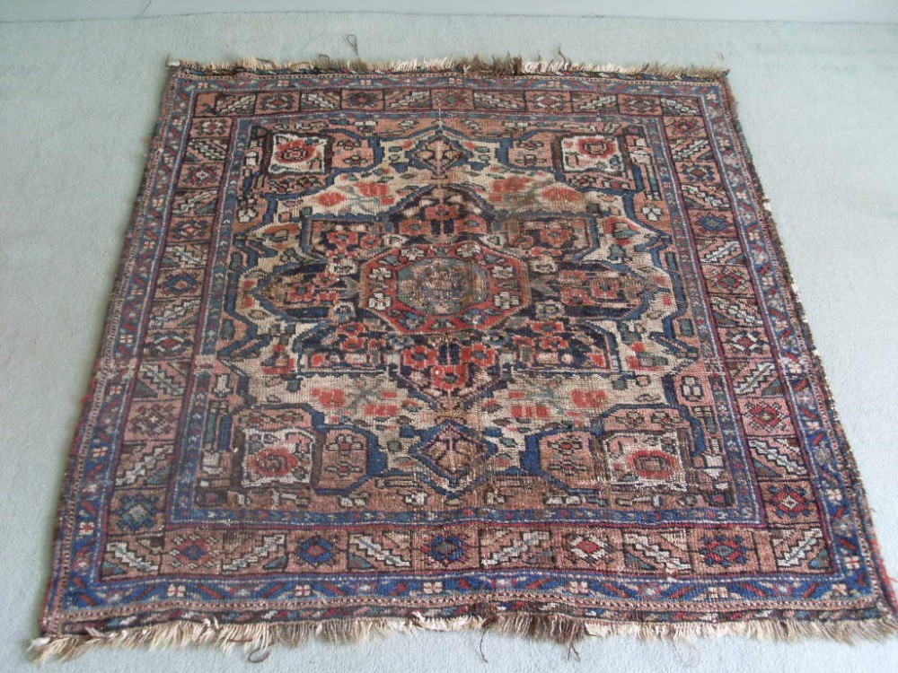 An antique caucasian rug 104 x 113 cms