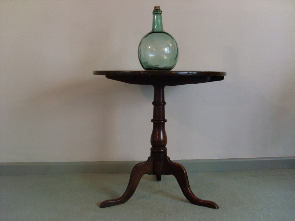 A Georgian oak tilt top tripod table