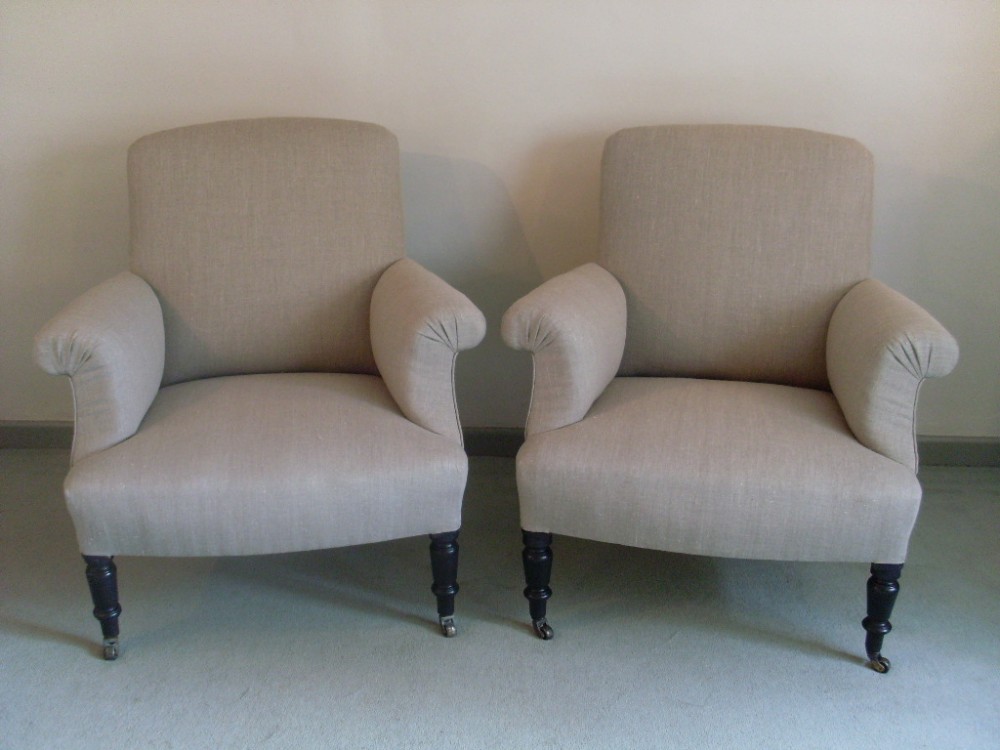 A pair of French upholstered armchairs