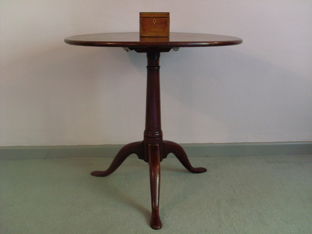 A Georgian tilt top tripod table with one piece top