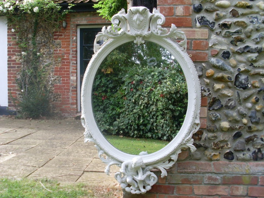 A substantial and decorative 19thC oval wall mirror