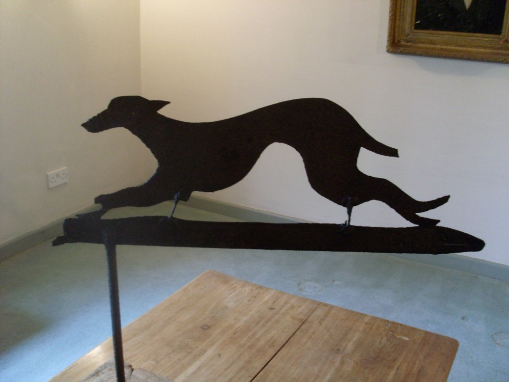 A mounted decorative antique hound weather vane