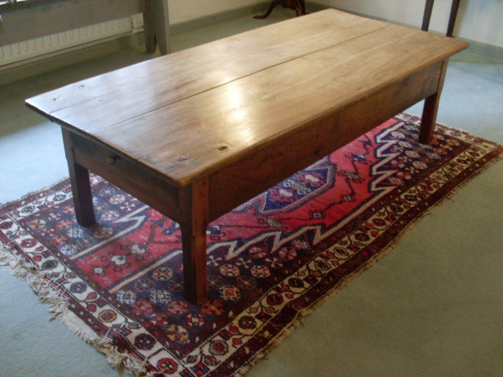 A huge early 19thC elm topped coffee table