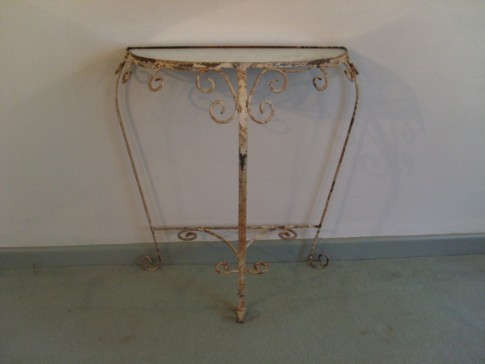 An iron mirror topped console table