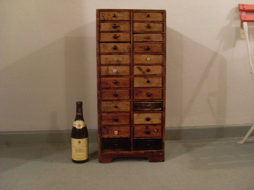An antique pine bank of 24 drawers 