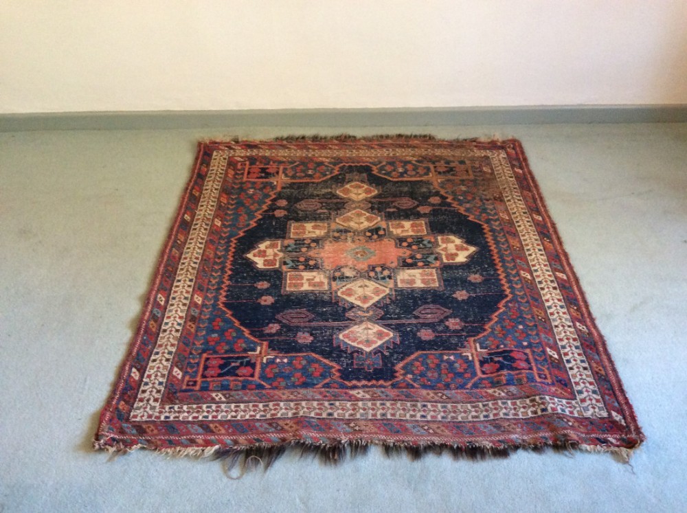 An antique area rug