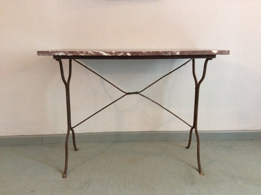 A French marble topped table with an iron base