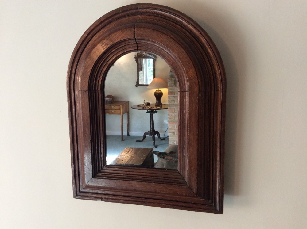 An interesting gothic oak wall mirror
