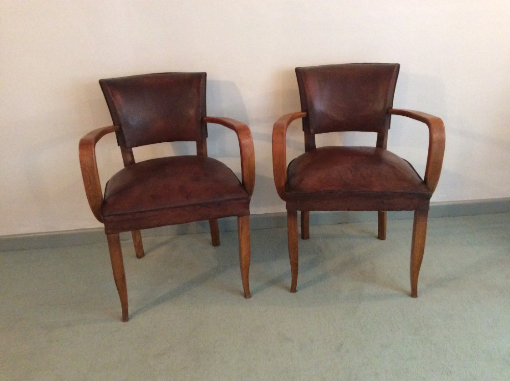 A pair of French leather covered bridge chairs