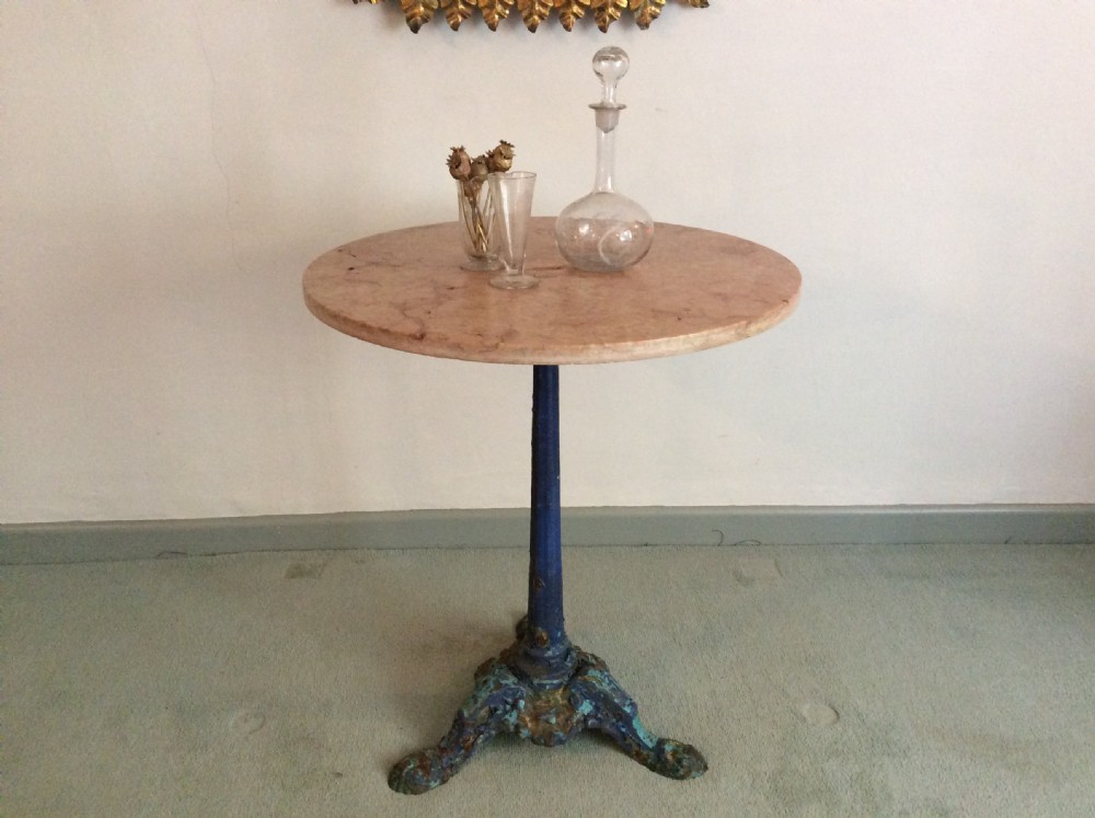 A French cast iron based pedestal table with marble top