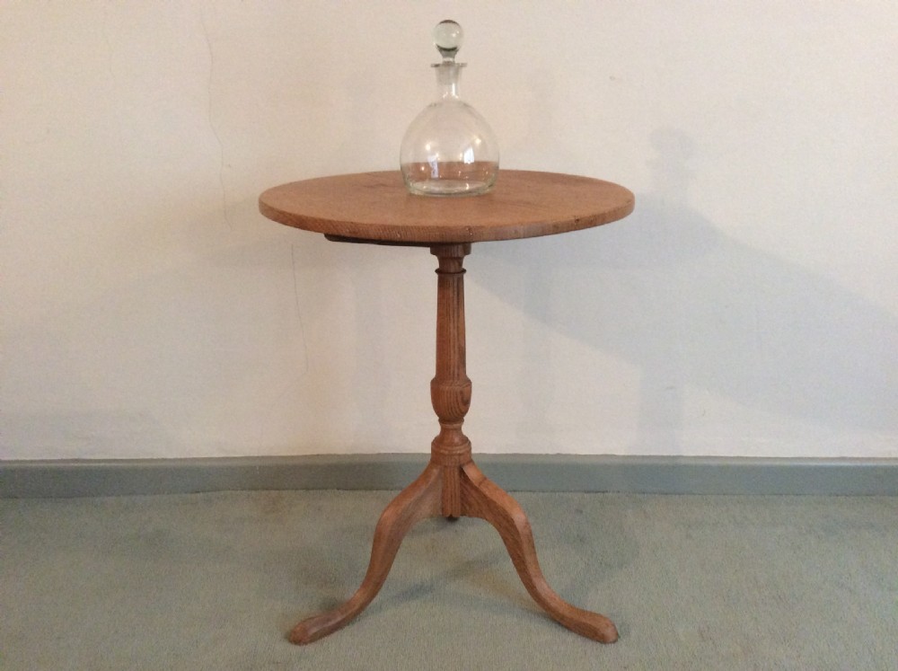 A 54 cm dia bleached oak and elm tripod  table