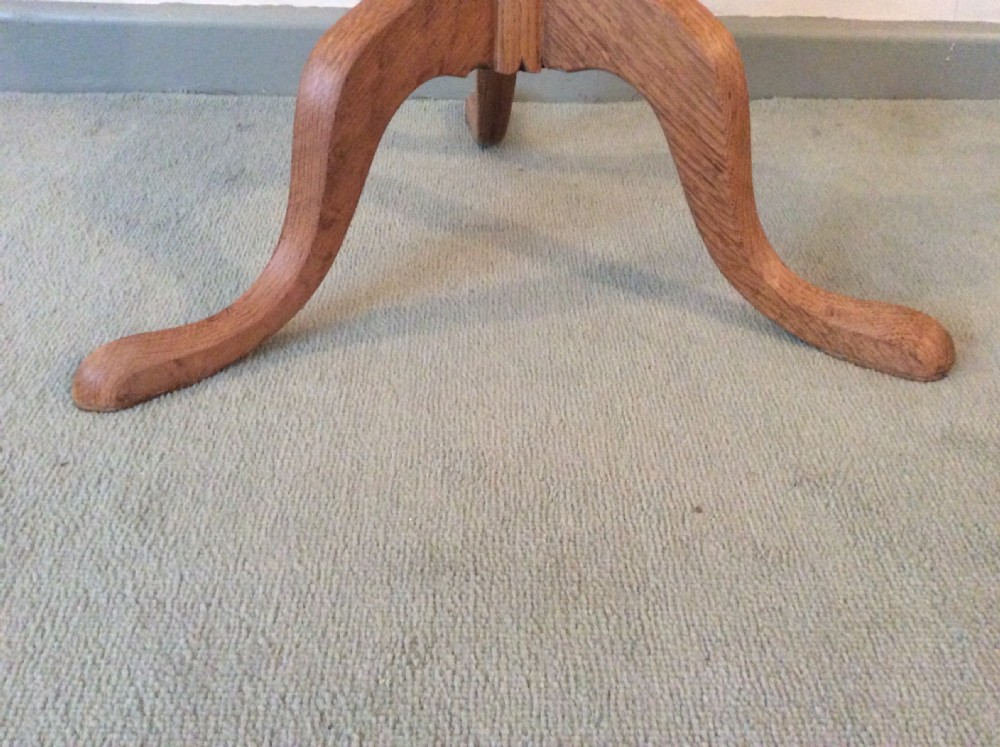A 54 cm dia bleached oak and elm tripod  table View V
