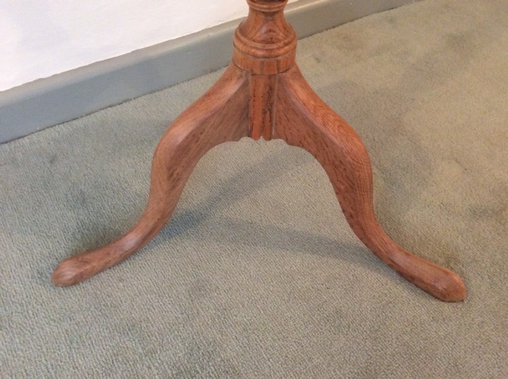 A 54 cm dia bleached oak and elm tripod  table View IX