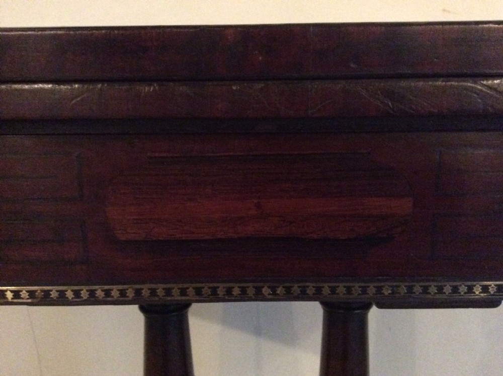 A Regency rosewood brass inlaid hall table View V