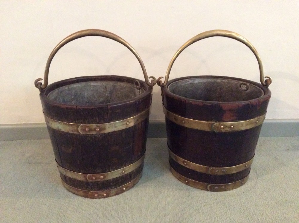 A near pair of antique peat buckets