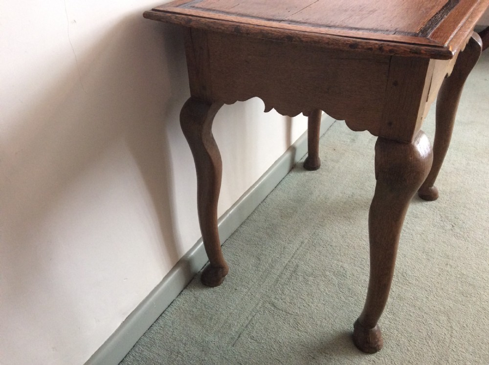 An 18thC oak hoof foot lowboy View VI