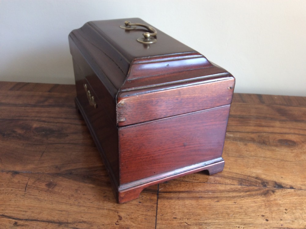 A dark mahogany Georgian tea caddy featuring a stepped lid with a top brass handle and a central brass keyhole escutcheon. View III