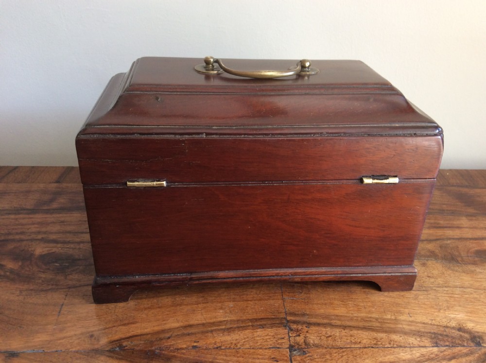 A dark mahogany Georgian tea caddy featuring a stepped lid with a top brass handle and a central brass keyhole escutcheon. View VI