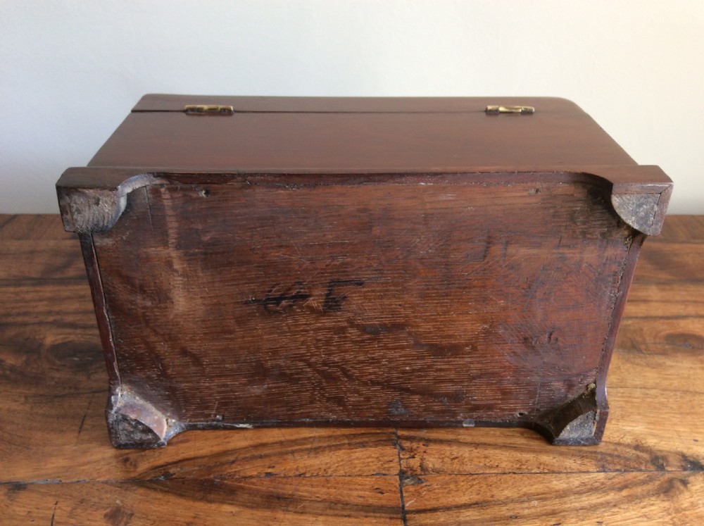 A dark mahogany Georgian tea caddy featuring a stepped lid with a top brass handle and a central brass keyhole escutcheon. View VII