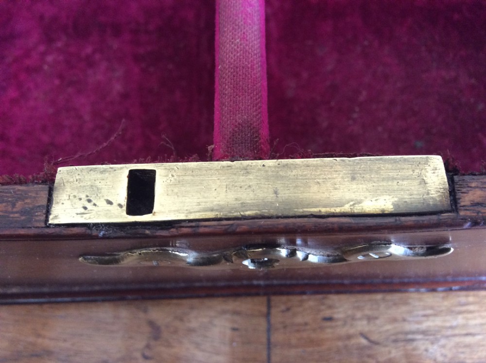 A dark mahogany Georgian tea caddy featuring a stepped lid with a top brass handle and a central brass keyhole escutcheon. View X