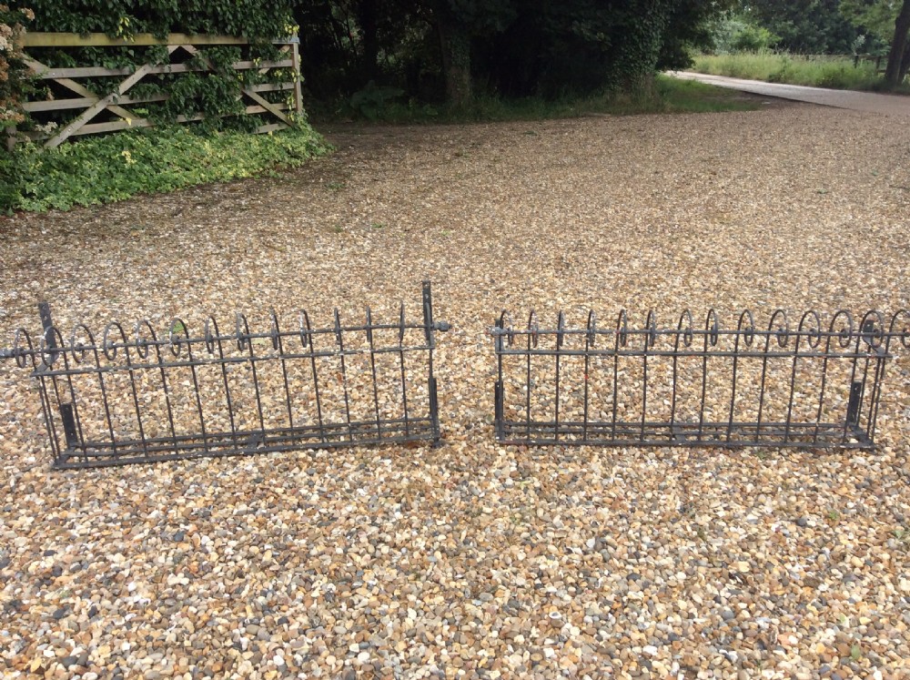 A pair of 19thC iron balcony window box railings