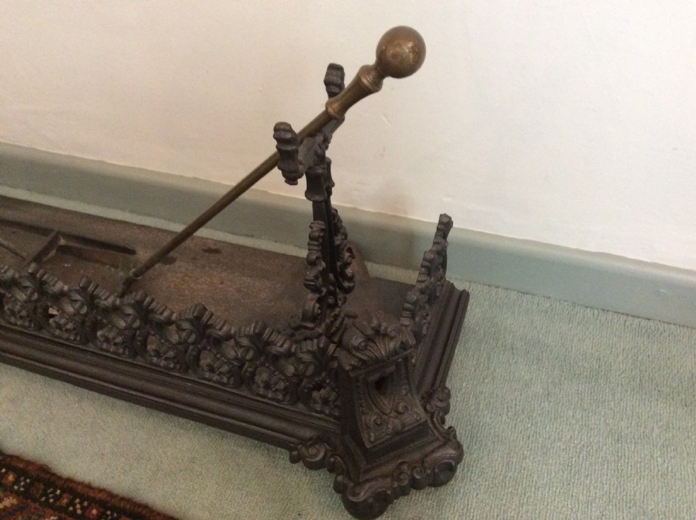 A large ornate Victorian cast iron fender View II
