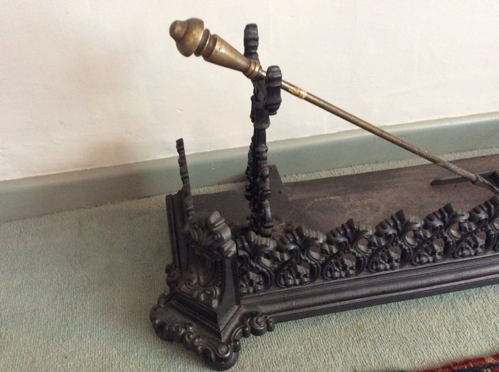 A large ornate Victorian cast iron fender View III