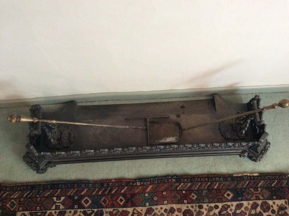 A large ornate Victorian cast iron fender View V