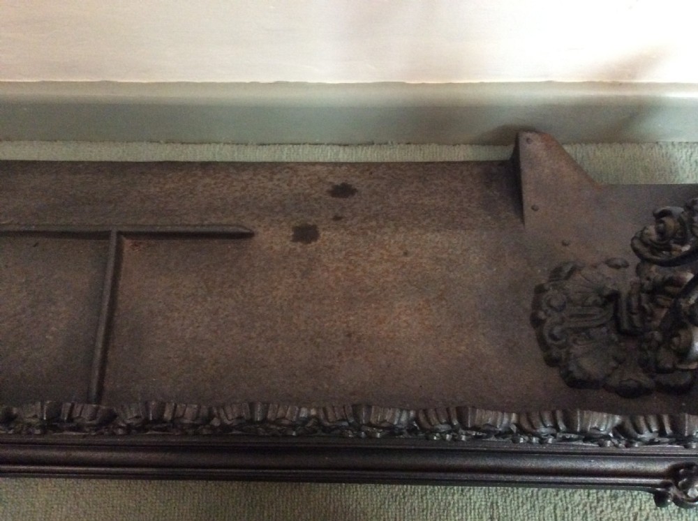 A large ornate Victorian cast iron fender View IX