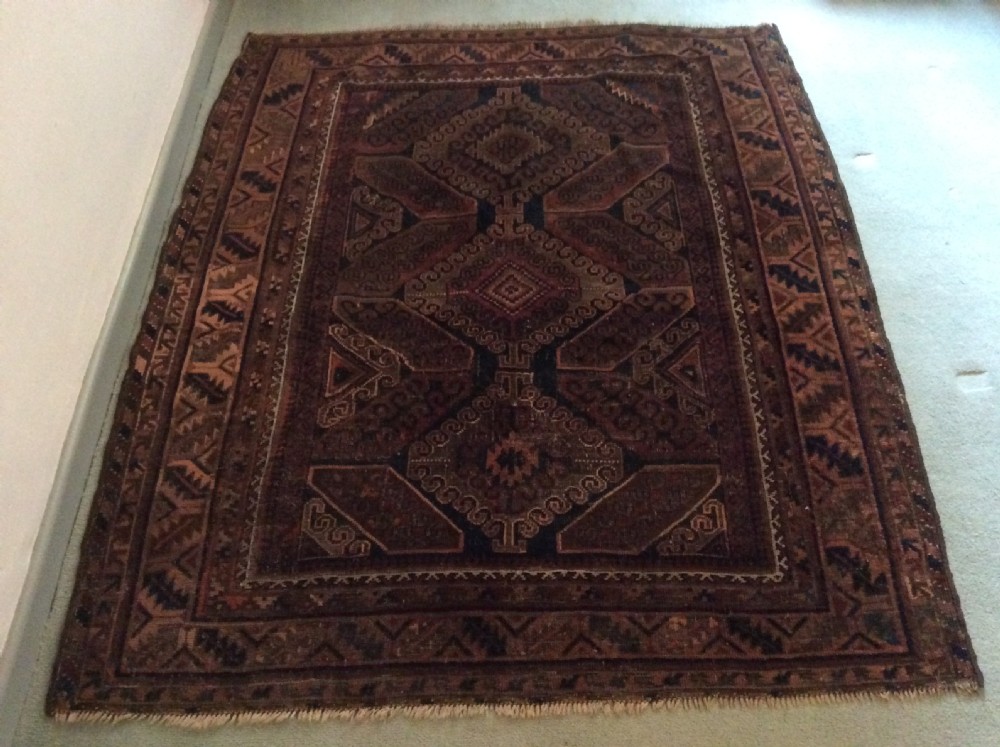 An antique rug 172 x 140 cm