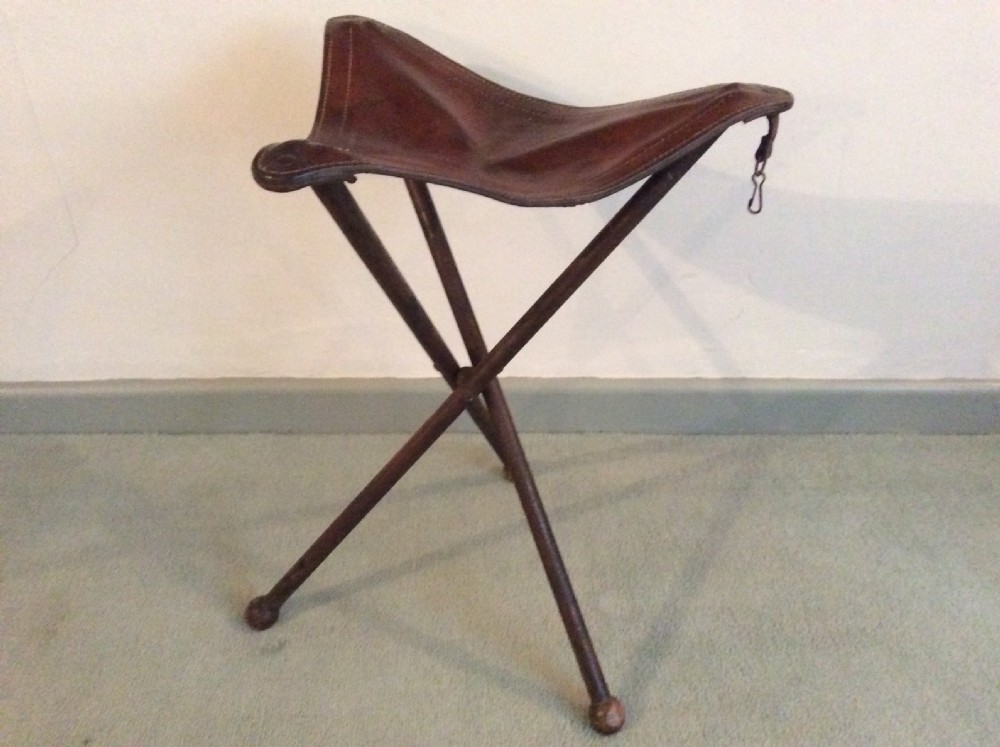 A folding leather campaign stool
