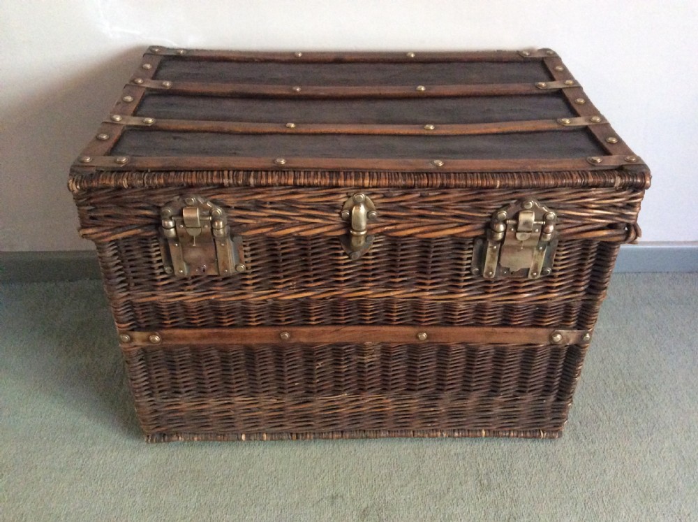 A French wicker and brass laundry basket