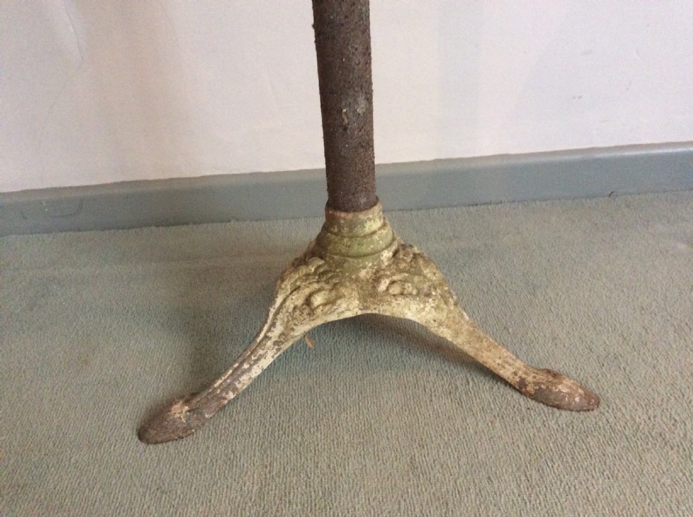 A cast metal and iron garden table View II