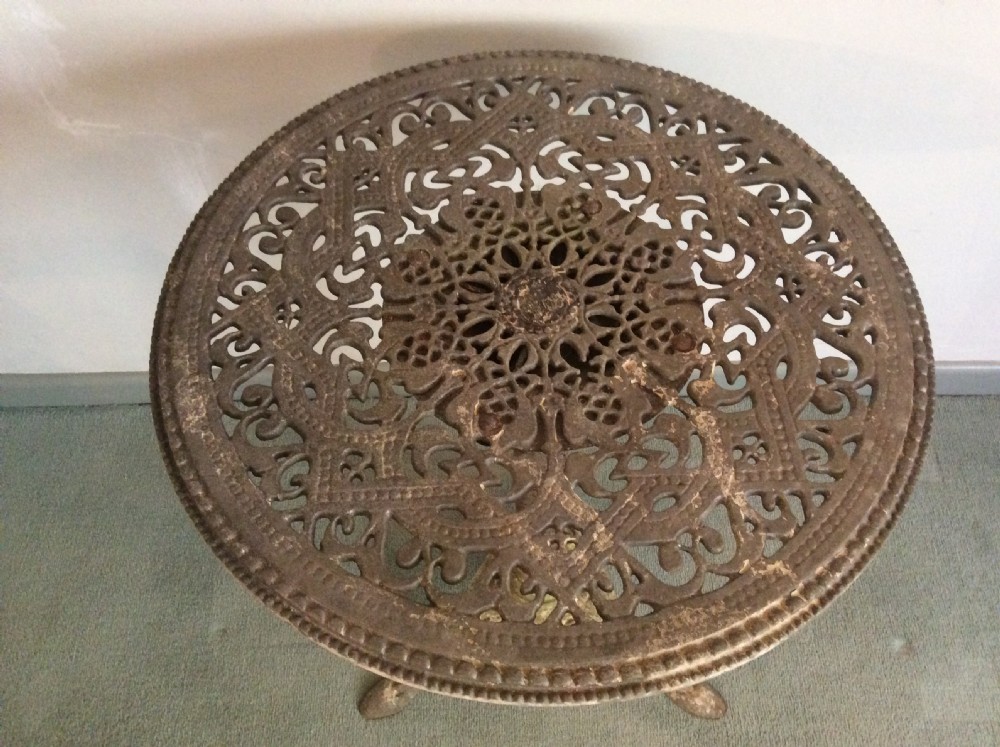 A cast metal and iron garden table View IV