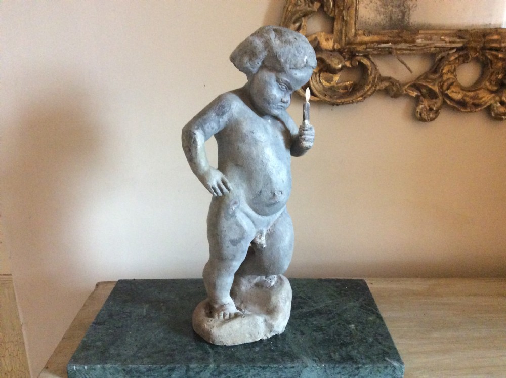 A small late 19thC lead cherub garden feature