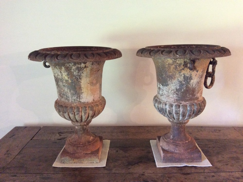 A pair of 19thC cast iron urns