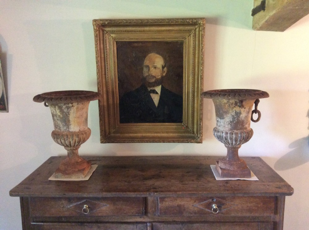 A pair of 19thC cast iron urns View II