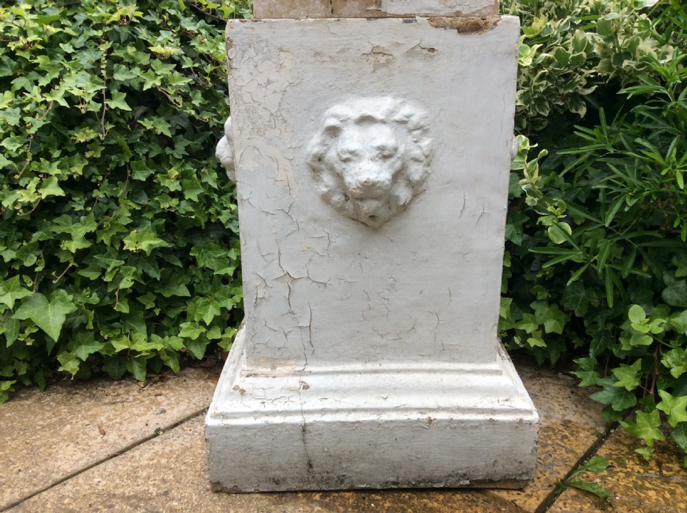 A pair of white painted 19th-century cast iron garden urns featuring gadrooned basins set upon square pedestals with lion head relief motifs. View VII