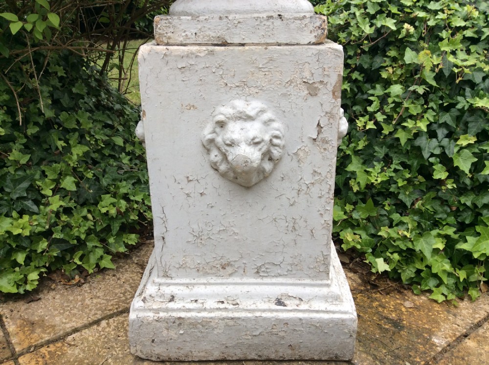 A pair of white painted 19th-century cast iron garden urns featuring gadrooned basins set upon square pedestals with lion head relief motifs. View VIII