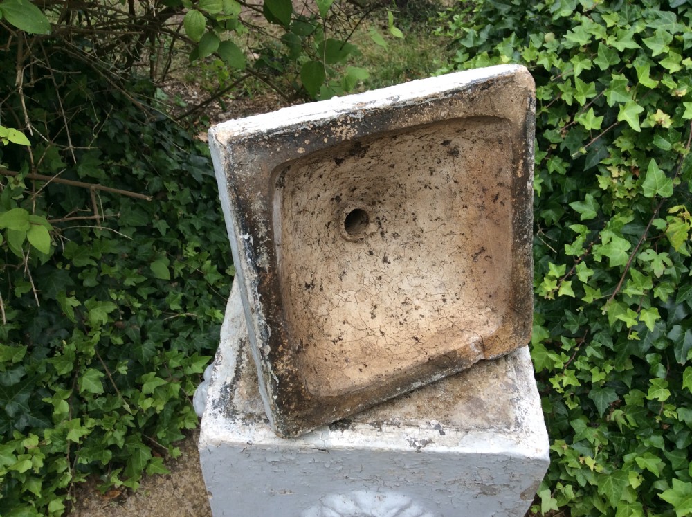 A pair of white painted 19th-century cast iron garden urns featuring gadrooned basins set upon square pedestals with lion head relief motifs. View XII