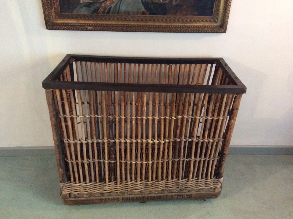 An early 20thC wheeled laundry basket 