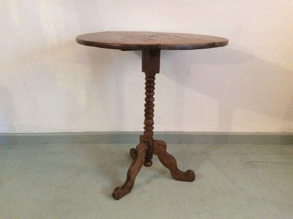An antique French oak tripod table