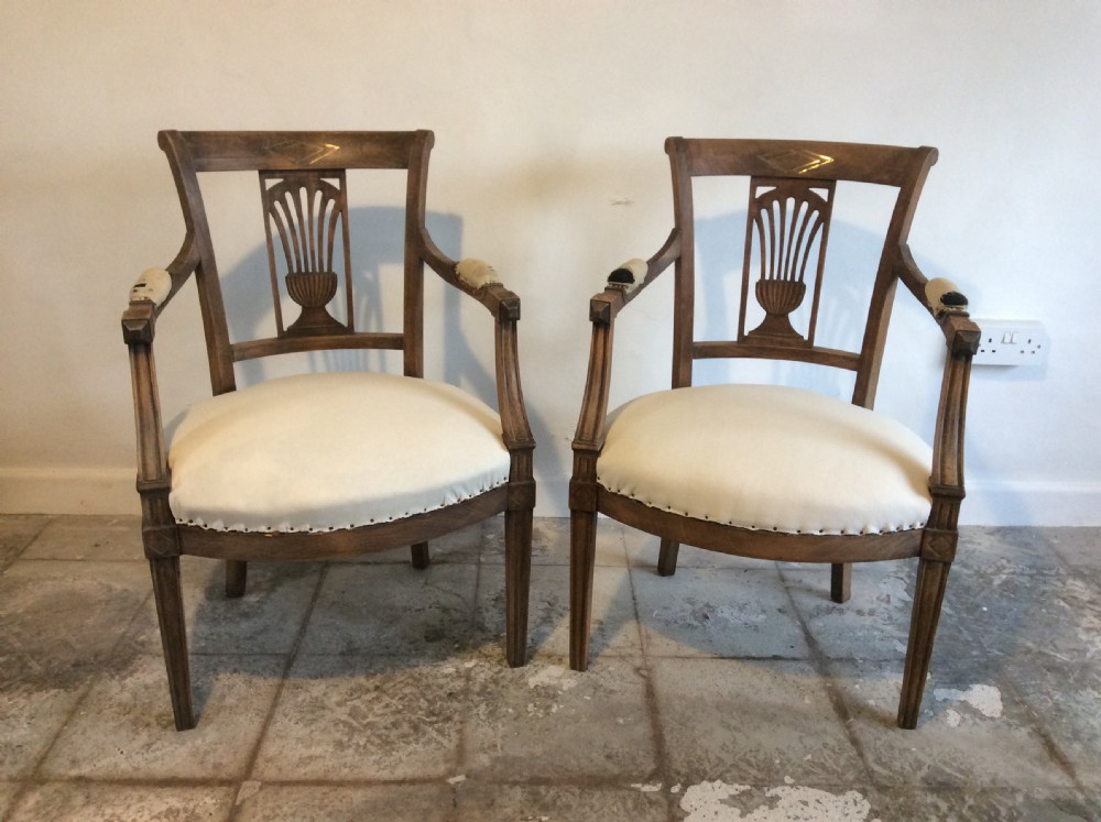 A pair of Edwardian open armchairs