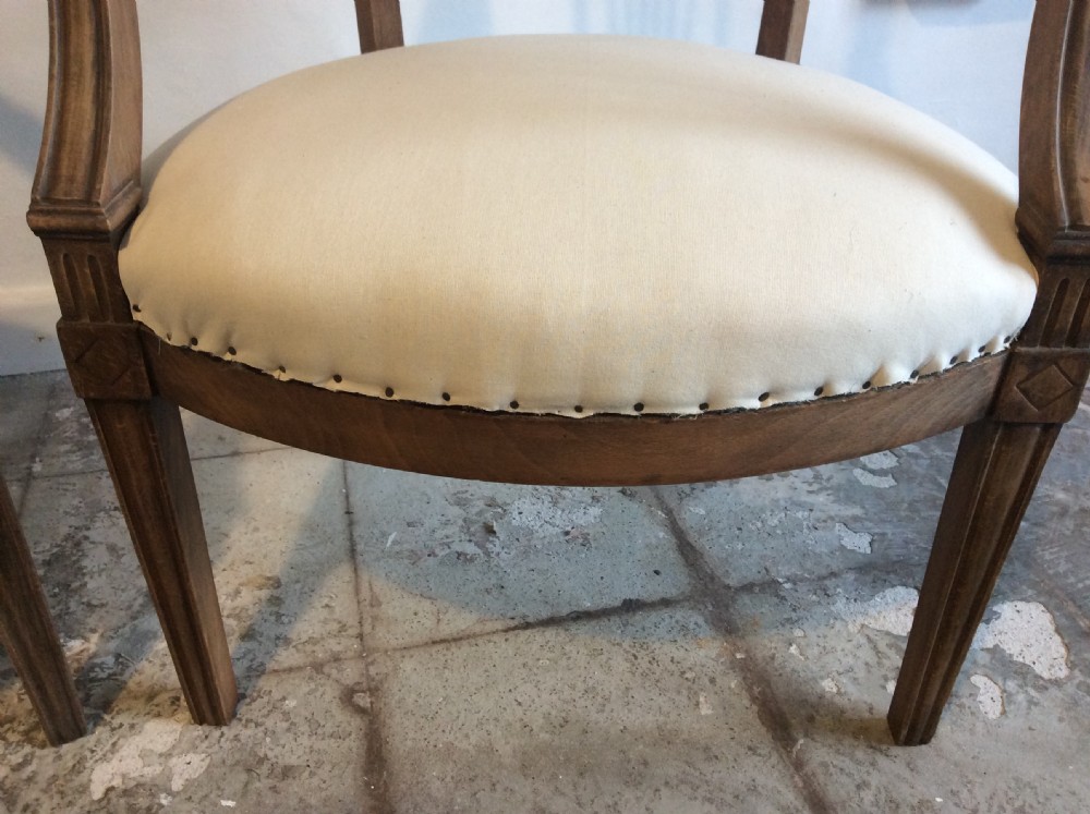 A pair of Edwardian open armchairs View V
