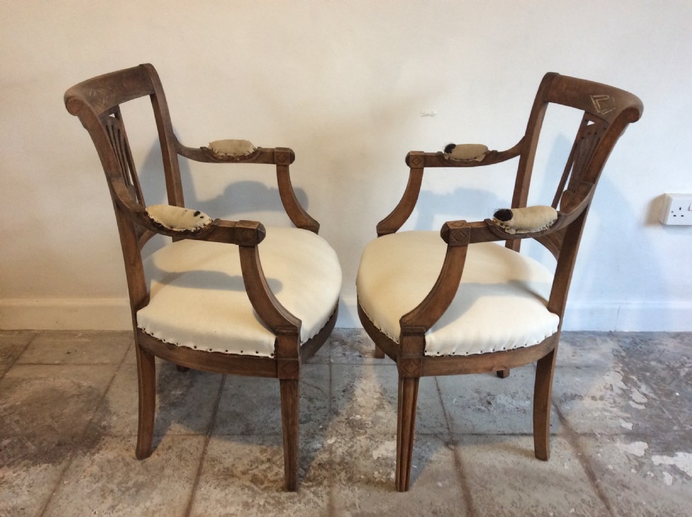 A pair of Edwardian open armchairs View VI