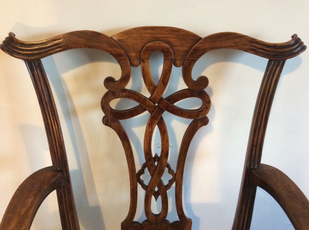 A Georgian George III elm open armchair featuring a pierced strapwork splat back, curved armrests, and a patterned upholstered seat. View III
