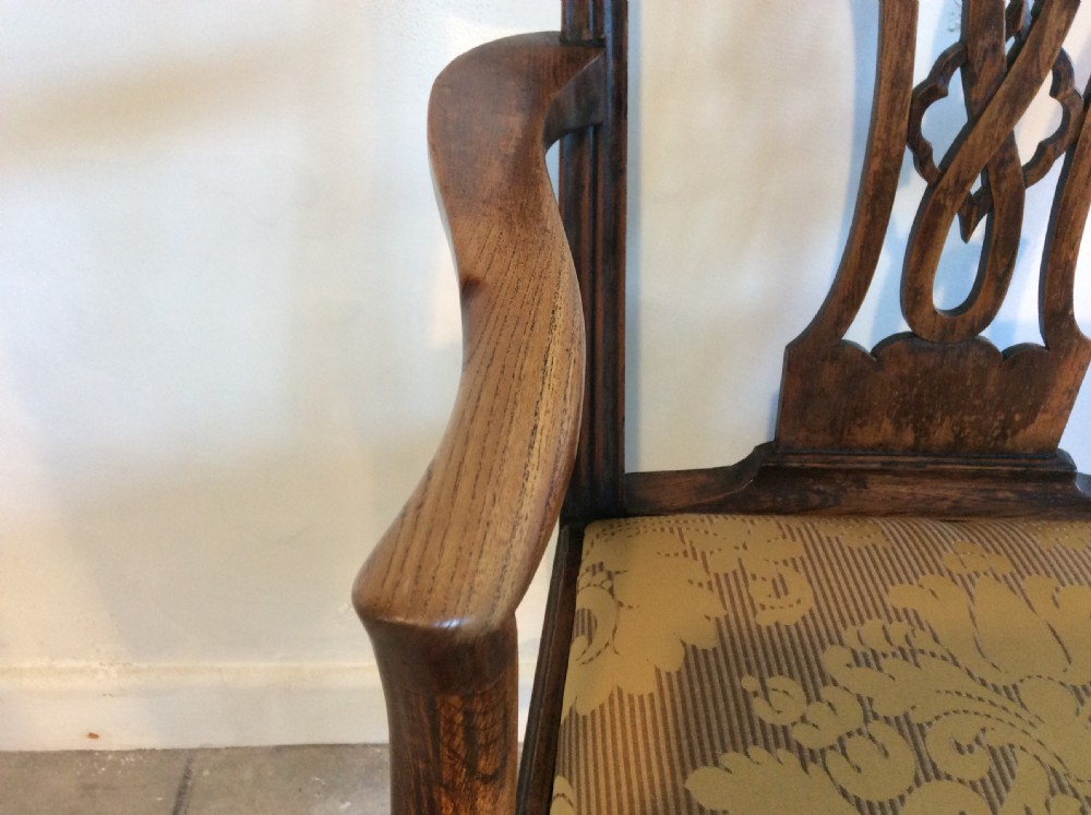 A Georgian George III elm open armchair featuring a pierced strapwork splat back, curved armrests, and a patterned upholstered seat. View IV