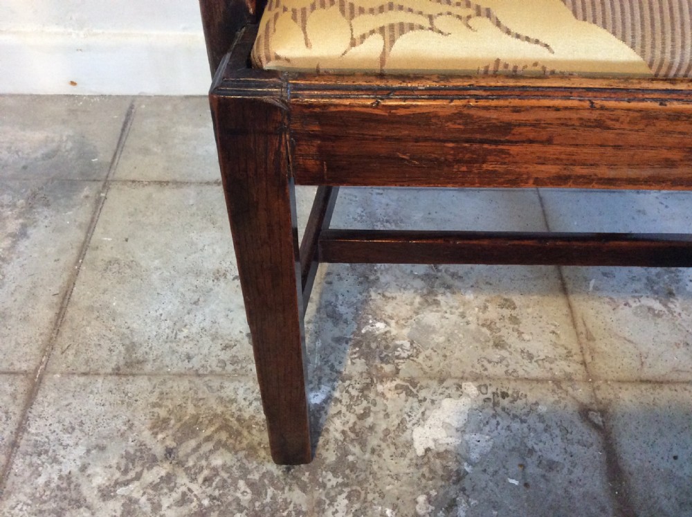 A Georgian George III elm open armchair featuring a pierced strapwork splat back, curved armrests, and a patterned upholstered seat. View VII